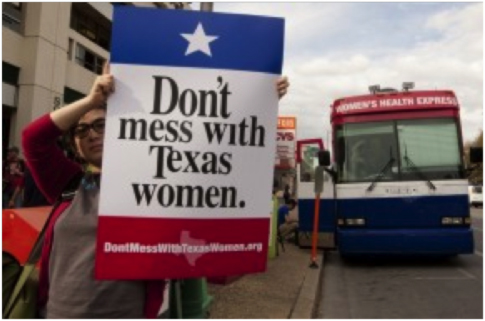 Woman protesting Perry's Planned Parenthood budget cuts