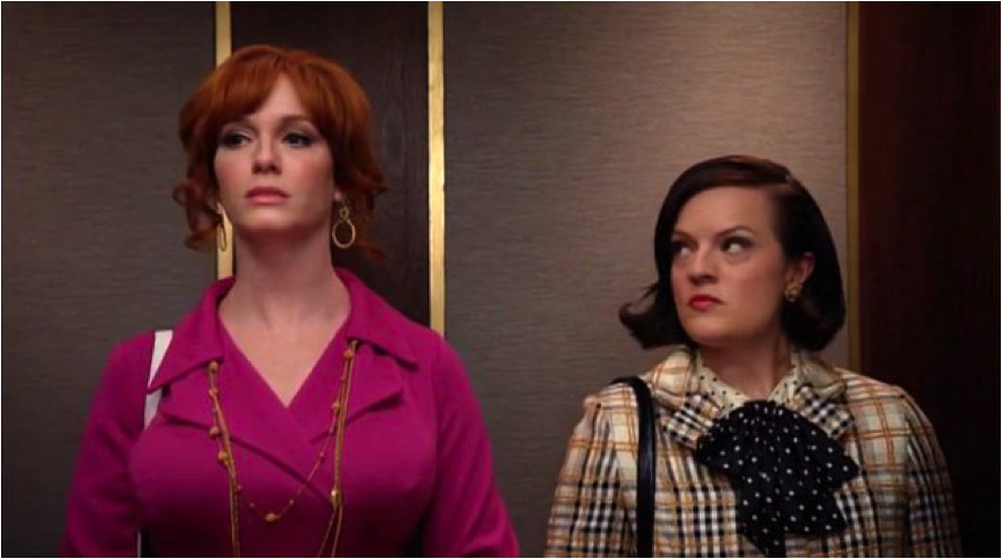 Peggy Olson and Joan Holloway ride the elevator up to Sterling Cooper’s offices